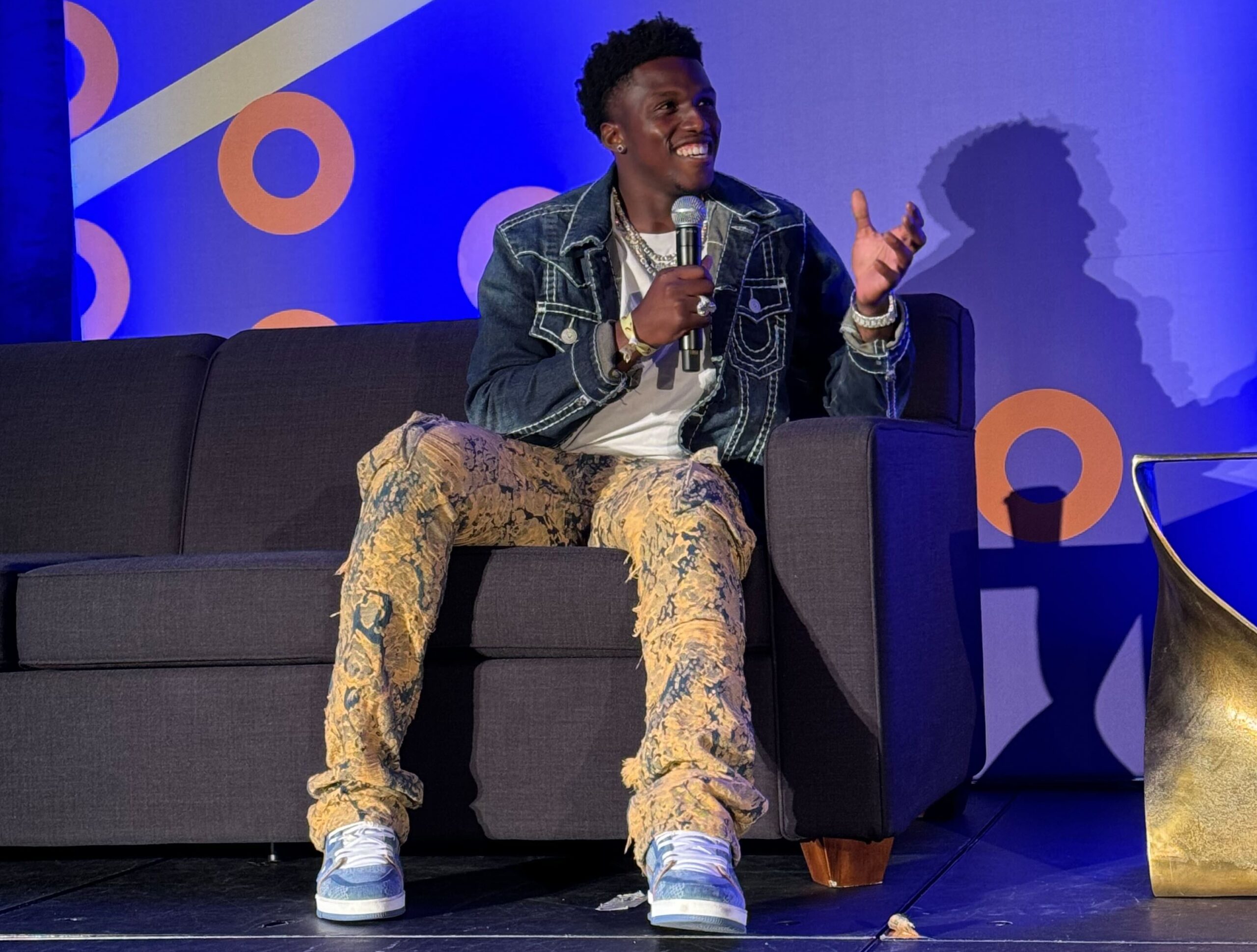 Anthony Hamilton Jr sitting on couch speaking through mic